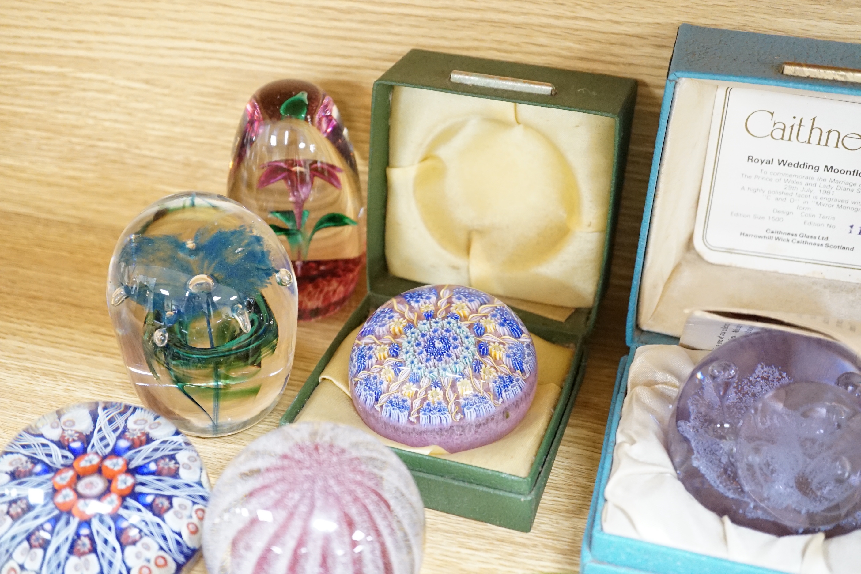 A collection of coloured glass paperweights including Strathearn, Caithness (28)